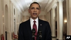 President Barack Obama reads his statement to photographers after making a televised statement on the death of Osama bin Laden from the East Room of the White House in Washington, Sunday, May 1, 2011. (AP Photo/Pablo Martinez Monsivais)