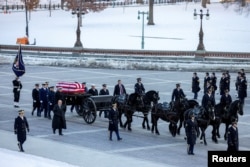 The casket of former U.S. President Jimmy Carter arrives on a horse-drawn caisson to the U.S. Capitol in Washington, Jan. 7, 2025.