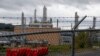 FILE - The MarkWest Bluestone Gas Processing Plant is visible behind the roadside fencing in Evans City, Pa., Oct. 17, 2019.