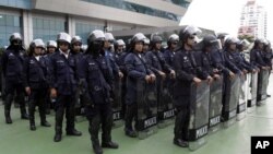 Thai riot policemen stand guard outside the Constitution Court during a ruling Friday, July 13, 2012 in Bangkok, Thailand.