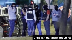 French policemen take part in a police raid in Boussy-Saint-Antoine near Paris, France, September 8, 2016. French police investigating the abandonment of a car packed with gas cylinders near Paris's Notre Dame cathedral last Saturday, arrested three women