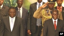 PM Morgan Tsvangirai (L) and President Robert Mugabe (R) are pictured at Zimbabwe International Investment Conference in Harare, 09 Jul 2009