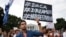 Carlos Esteban, 31, of Woodbridge, Va., a nursing student and recipient of Deferred Action for Childhood Arrivals, known as DACA, rallies with others in support of DACA outside of the White House, in Washington, Sept. 5, 2017. 
