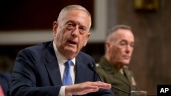 Defense Secretary Jim Mattis, left, accompanied by Joint Chiefs Chairman Gen. Joseph Dunford, speaks on Afghanistan before the Senate Armed Services Committee on Capitol Hill in Washington, Oct. 3, 2017. 