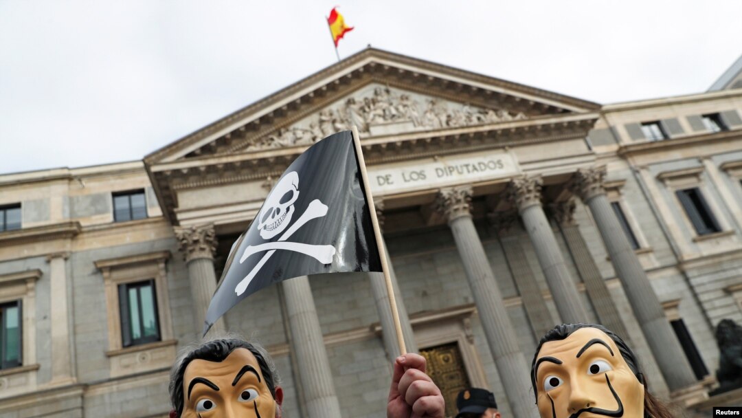 People protest a bill to legalize euthanasia as the Spanish parliament prepares to vote on it, outside the Spanish parliament in Madrid, Dec. 17, 2020.