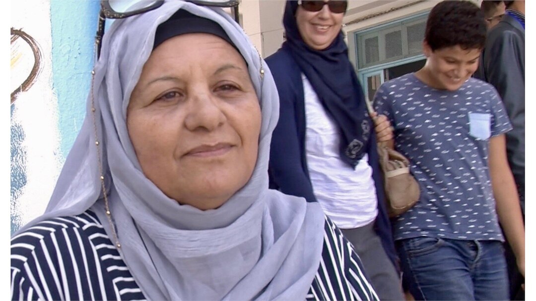 Zohra Goummid is voting for Prime Minister Youssef Chahed for president, Tunis, Sept. 15, 2019. (Photo: L. Bryant/VOA)