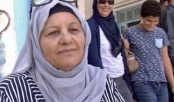 Zohra Goummid is voting for Prime Minister Youssef Chahed for president, Tunis, Sept. 15, 2019. (Photo: L. Bryant/VOA)