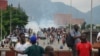 FILE - Police fired tear gas during a protest in Abuja, Nigeria, Thursday, Aug. 1, 2024. Thousands of mostly young people poured onto the streets across Nigeria on Thursday as they protested against the country's worst cost-of-living crisis in a generation. 