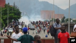 FILE - Police fired tear gas during a protest in Abuja, Nigeria, Thursday, Aug. 1, 2024. Thousands of mostly young people poured onto the streets across Nigeria on Thursday as they protested against the country's worst cost-of-living crisis in a generation. 