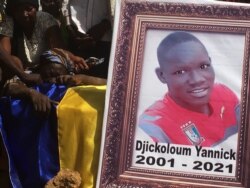 People mourn during the funeral of people killed at a protest this week in N'Djamena, Chad, Saturday, May 1, 2021.