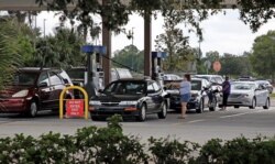 Local residents line up to fill their cars with gas ahead of the arrival of Hurricane Dorian in Kissimmee, Fla., Aug. 29, 2019.