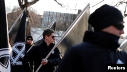 FILE - Members of Neo-Nazi groups are seen at a rally in Budapest, Hungary, Feb. 8, 2020.