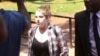 U.S. citizen Martha O'Donovan, escorted by plainclothes police, appears at the Harare Magistrates Court in Harare, Zimbabwe, Nov. 4, 2017. Police on Nov. 3 arrested and charged Donavan with subversion for allegedly insulting President Robert Mugabe on Twi