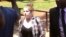 U.S. citizen Martha O'Donovan, escorted by plainclothes police, appears at the Harare Magistrates Court in Harare, Zimbabwe, Nov. 4, 2017. Police on Nov. 3 arrested and charged Donavan with subversion for allegedly insulting President Robert Mugabe on Twi