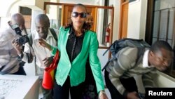 FILE - Kenyan marathon runner Rita Jeptoo walks past photographers as she arrives at the Athletics Kenya headquarters after failing a doping test, in Kenya's capital Nairobi, January 15, 2015.