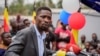 FILE - Ugandan opposition figure Bobi Wine, whose real name is Kyagulanyi Ssentamu, speaks in Kampala, Uganda, Feb. 22, 2021. Ugandan police fired tear gas and arrested more than 30 opposition supporters attending a Friday prayer rally organized by Wine.