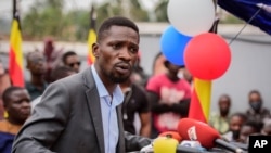 FILE - Ugandan opposition figure Bobi Wine, whose real name is Kyagulanyi Ssentamu, speaks in Kampala, Uganda, Feb. 22, 2021. Ugandan police fired tear gas and arrested more than 30 opposition supporters attending a Friday prayer rally organized by Wine.