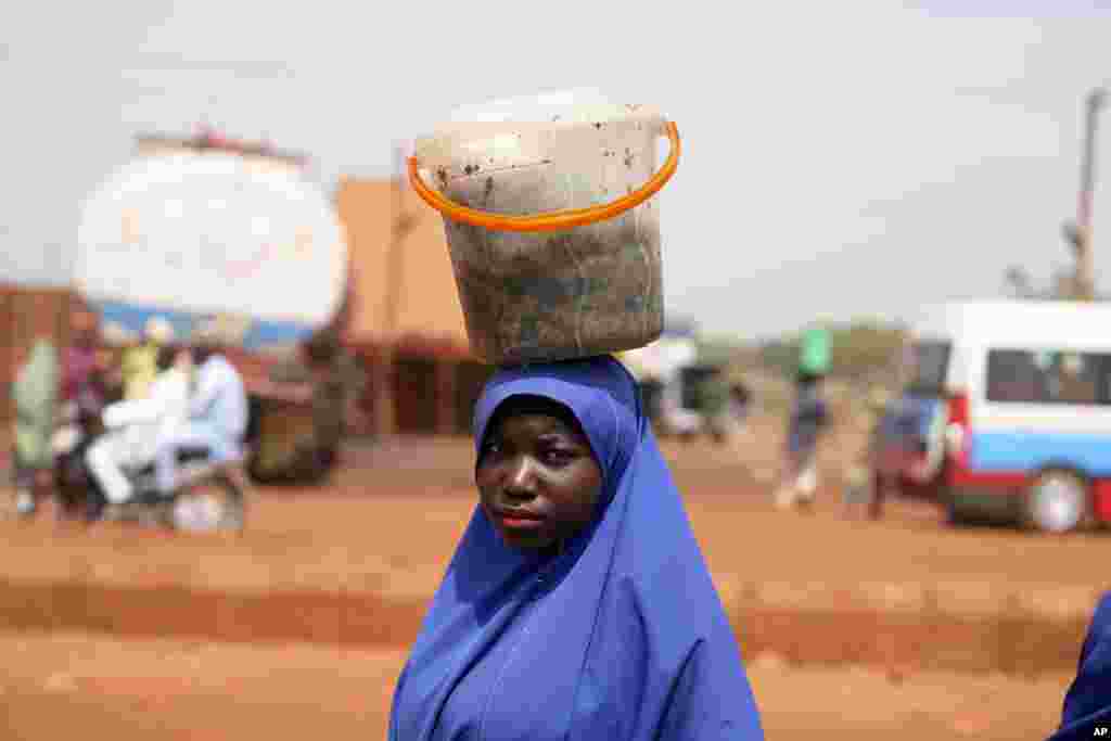 A woman sells cooked cabbage leaves on a road side market in Sokoto, Nigeria.