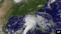 This NOAA satellite image shows shower and thunderstorm activity developing around an area of low pressure spinning in the Gulf of Mexico, June 23, 2012.