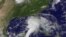 This NOAA satellite image shows shower and thunderstorm activity developing around an area of low pressure spinning in the Gulf of Mexico, June 23, 2012.