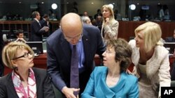 France's FM Alain Juppe (2nd L) greets European Union High Representative for Foreign Affairs and Security Policy Catherine Ashton (2nd R) during an EU foreign ministers meeting at the EU Council in Brussels, May 23, 2011