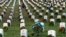 Lane Austin, 6, of Virginia Beach, carries a wreath to grave during Wreaths Across America at Arlington National Cemetery, &nbsp;in Arlington, Virginia, Dec. 12, 2015.