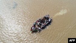 An aerial view of locals being rescued on a boat in waterlogged Jamkhandi Taluk at Belgaum district of Karnataka state in the south Indian city of Bangalore, Aug. 11, 2019.