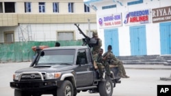 Soldiers patrol outside the Hayat Hotel in Mogadishu, Somalia, Aug, 20, 2022. At least 10 people were killed in an attack by Islamic militants who stormed the hotel late Friday, police and eyewitnesses said. 