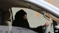 FILE - A woman drives a car on a highway in Riyadh, Saudi Arabia, as part of a campaign to defy Saudi Arabia's ban on women driving, March 29, 2014. Women's rights activists are among those being detained in Saudi Arabia. 