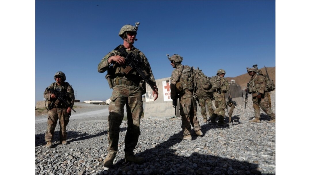 FILE - U.S. troops wait for their helicopter flight at an Afghan National Army (ANA) base in Logar province, Afghanistan, Aug. 7, 2018.