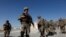 FILE - U.S. troops wait for their helicopter at an Afghan National Army (ANA) base in Logar province, Afghanistan, Aug. 7, 2018.