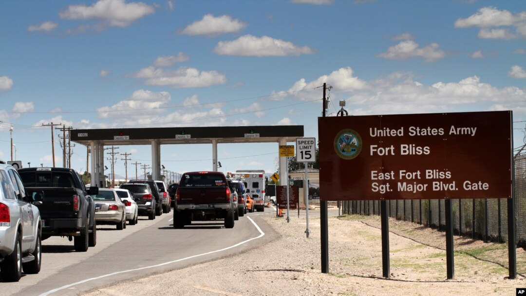 FILE - This Sept. 9, 2014 file photo shows cars wait to enter Fort Bliss in El Paso, Texas. 