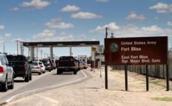 FILE - This Sept. 9, 2014 file photo shows cars wait to enter Fort Bliss in El Paso, Texas.