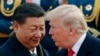 FILE - U.S. President Donald Trump, right, chats with Chinese President Xi Jinping, on Aug. 31, 2019, in Beijing. 