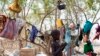 A young boy stands in front of the tree in a camp for the displaced in Mingkamen, where he and his family fled as violence raked the town of Bor in Jonglei state.