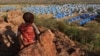 FILE - A boy looks over a refugee camp near the Chad-Sudan border, Nov. 9, 2023. Hundreds of Masalit families from Sudan's West Darfur state were sent here following a massacre in El Geneina. Sudan claims the UAE supplied arms to paramilitary forces in relation to the attacks.