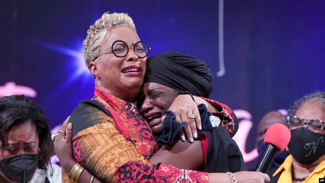 The Rev. Gina Stewart, left, senior pastor of Christ Missionary Baptist Church, comforts Hatshepsut Bandele during a church service Dec. 5, 2021, in Memphis, Tenn.