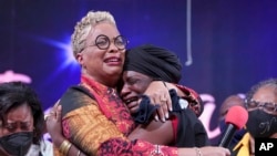 The Rev. Gina Stewart, left, senior pastor of Christ Missionary Baptist Church, comforts Hatshepsut Bandele during a church service Dec. 5, 2021, in Memphis, Tenn.