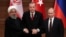 FILE - Presidents Hassan Rouhani of Iran, Recep Tayyip Erdogan of Turkey and Vladimir Putin of Russia hold a joint news conference after their meeting in Ankara, Turkey, April 4, 2018.