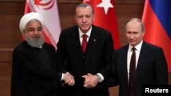 Presidents Hassan Rouhani of Iran, Recep Tayyip Erdogan of Turkey and Vladimir Putin of Russia hold a joint news conference after their meeting in Ankara, Turkey, April 4, 2018.