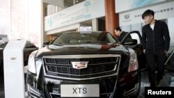 Customer Wang Pan looks around Cadillac's XTS model at its dealership in Beijing, China, March 14, 2016.