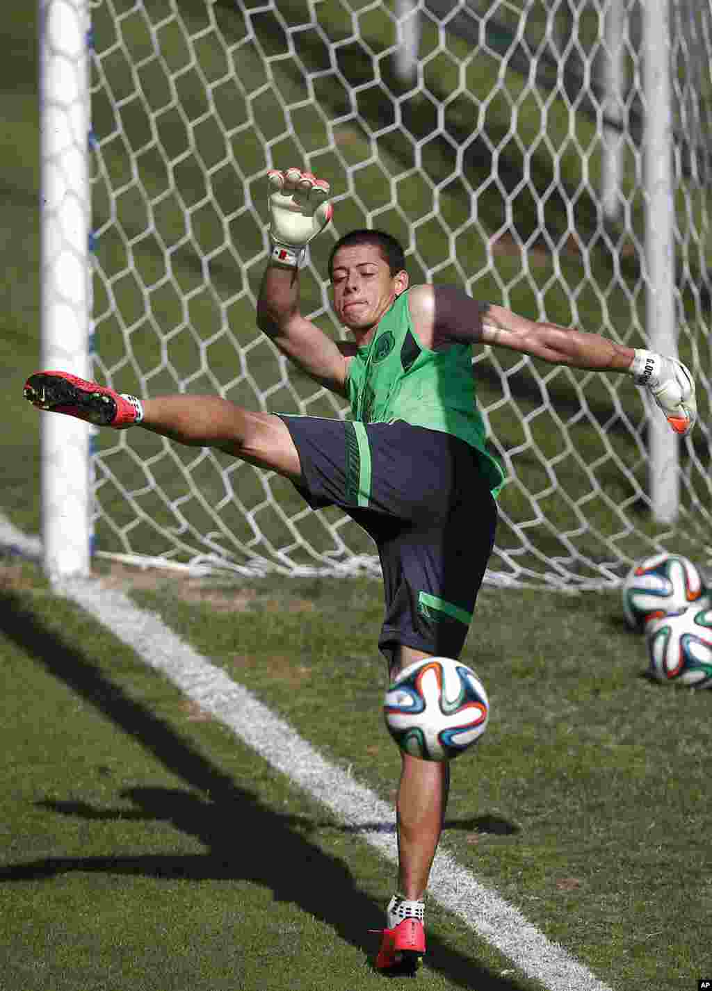 Mexico's national soccer player Javier Hernandez kicks the ball during a training session in Santos, Brazil, June 8, 2014. 