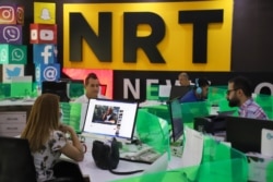 FILE - Journalists are pictured in the newsroom of Nalia Radio and Television (NRT) in Sulaimaniyah city, in the Kurdish autonomous region of northern Iraq, Aug. 22, 2020.