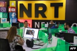 FILE - Journalists are pictured in the newsroom of Nalia Radio and Television (NRT) in Sulaimaniyah city, in the Kurdish autonomous region of northern Iraq, Aug. 22, 2020.