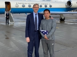 In this image released by the US State Department US Special Representative for Iran Brian Hook welcomes Princeton graduate student Xiyue Wang on arrival in Switzerland after his release from Iran on Dec. 7, 2019. (Ho /US State Department/AFP)