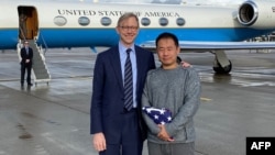 FILE - In this image released by the US State Department US Special Representative for Iran Brian Hook welcomes Princeton graduate student Xiyue Wang on arrival in Switzerland after his release from Iran on Dec. 7, 2019. (Ho/US State Department/AFP)