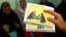FILE - A counselor holds up cards used to educate women about female genital mutilation (FGM).