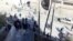 A handout picture released by the Syrian Arab News Agency shows Syrians inspecting the site of a car bomb blast in the northwestern city of Idlib, January 16, 2013.