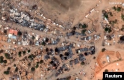 FILE - A satellite image shows a view after attacks at the entrance to Zamzam camp and burned market buildings in Sudan, Feb. 13, 2025. (Maxar Technologies/Handout via Reuters)