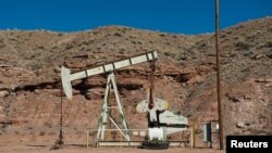 FILE - Oil pump jacks are seen near Aneth, Utah, Oct. 29, 2017.